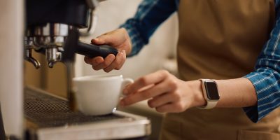 Close up of waitress making coffee in a cafe. Close up of waitress making coffee in a cafe.